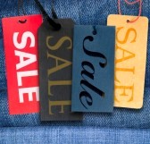 11879070-tags-with-sale-sign-with-stack-of-blue-jeans-in-background